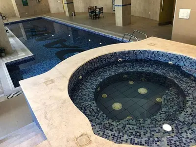 a swimming pool with a tile floor in a building at luxury apartment in boulevard in Amman