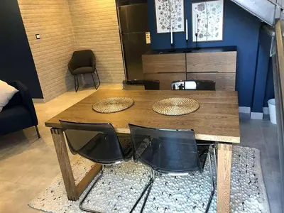 a wooden table and chairs in a room at luxury apartment in boulevard in Amman