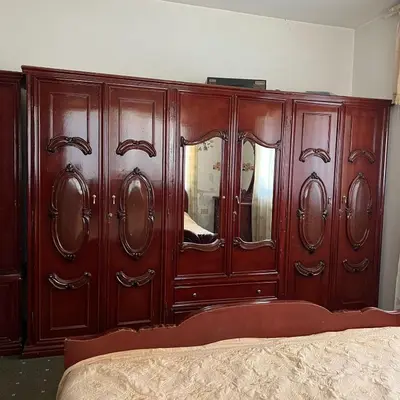 a wooden dresser with a mirror in a bedroom at Ajloun Rest House in ‘Ayn Jannā