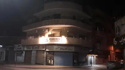 a building with a round top at night at Mesha Stele Private Hotel in Madaba