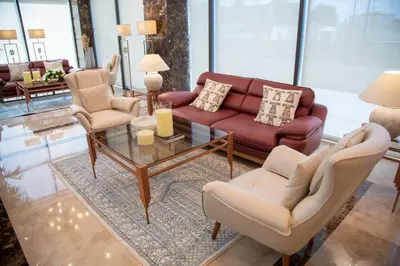 a living room with a couch and chairs and a table at Jeddah Homes Boutique Hotel in Amman