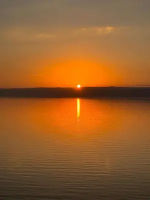 a sunset over a large body of water at Apartment at Samarah Dead Sea Resort APT D-09 in Sowayma