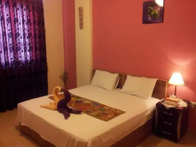 a bedroom with a bed with a stuffed animal on it at Jordan River Hotel in Amman