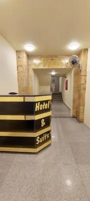 a hallway with a hotel and suites sign in a room at Venice in Aqaba