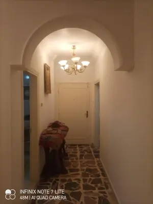 a hallway with a chandelier and a table in a room at Decapolis in Irbid