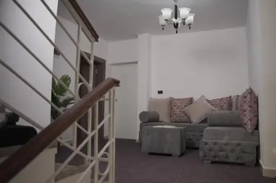 a living room with a couch and a chair at Petra Passion Inn in Taiyiba