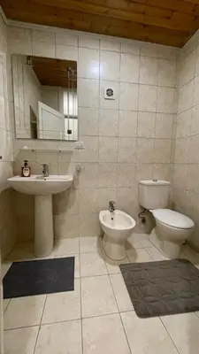 a bathroom with a toilet and a bidet and a sink at Abdoun Apartment in Amman