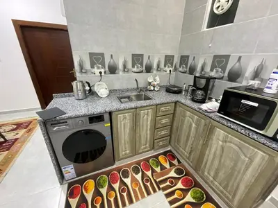 a kitchen with a stove and a bunch of donuts at Black IRIS in Jerash