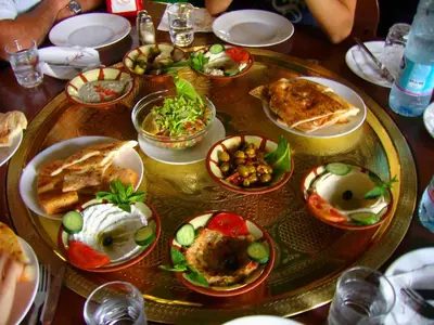 a table with plates of food on top of it at Black IRIS in Jerash