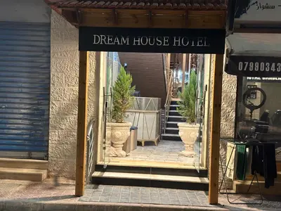 a dream house hotel sign in front of a store at Dream house hotel jerash in Jerash