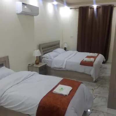 a hotel room with two beds with towels on them at Dream house hotel jerash in Jerash