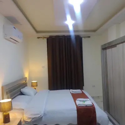 a bedroom with a large bed with a black curtain at Dream house hotel jerash in Jerash