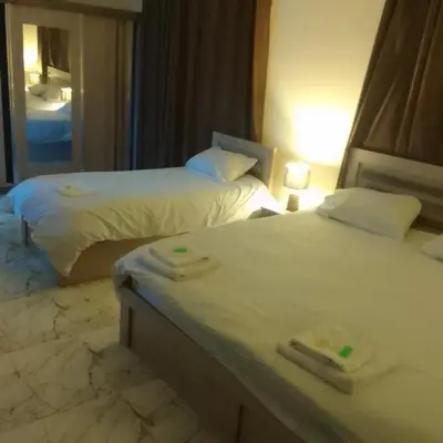 two beds in a hotel room with towels on them at Dream house hotel jerash in Jerash
