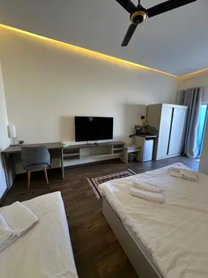 a hotel room with two beds and a flat screen tv at AQABA PRO DIVERS in Aqaba