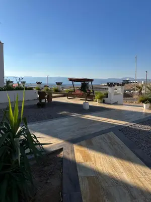 a patio with a picnic table and a view of the ocean at AQABA PRO DIVERS in Aqaba