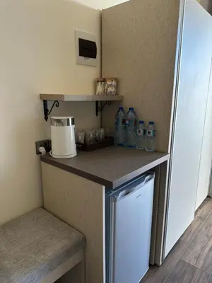 a kitchen with a refrigerator and a counter with water bottles at AQABA PRO DIVERS in Aqaba