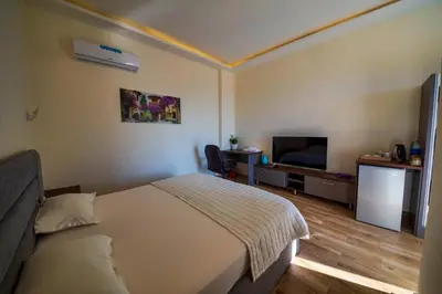 a hotel room with a bed and a flat screen tv at AQABA PRO DIVERS in Aqaba