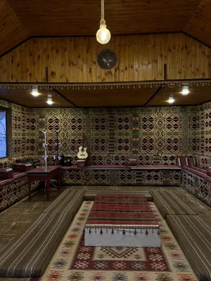 a room with a table and a rug on the floor at Full moon camp in Wadi Rum