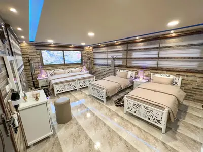 a room with four beds in a room at PETRA ROYAL HOUSE in Wadi Musa