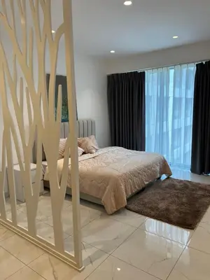 a bedroom with a bed and a large mirror at Modern studio in the heart of Amman in Amman