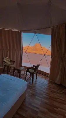 a room with a bed and a view of the desert at Lulua luxury camp in Wadi Rum