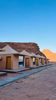 a row of buildings in the middle of the desert at Lulua luxury camp in Wadi Rum