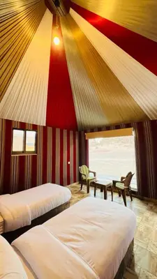 a bedroom with two beds and a red and yellow ceiling at Lulua luxury camp in Wadi Rum