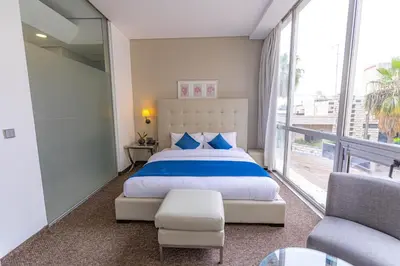 a bedroom with a large bed and a balcony at Boho Boutique Hotel Amman in Amman
