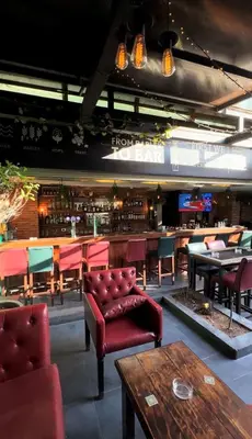 a restaurant with tables and chairs and a bar at Boho Boutique Hotel Amman in Amman
