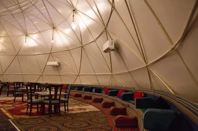 a room with chairs and tables in a domed ceiling at Desert Season Luxury Camp Wadi Rum Boutique Tents & Stargazing in Wadi Rum