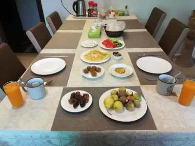 a long table with plates of food on it at ( b&b ) Gadara rent room in Um Qeis