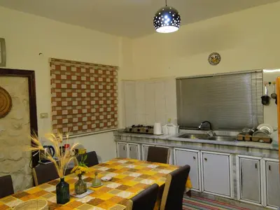 a kitchen with a table and a kitchen with a sink at ( b&b ) Gadara rent room in Um Qeis