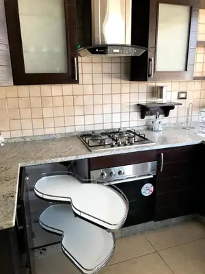a kitchen with two stools in front of a stove at MK6 - Two bedroom Apartment in Amman