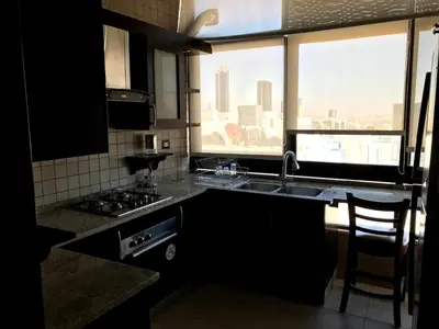 a kitchen with a sink and a stove and a window at MK6 - Two bedroom Apartment in Amman