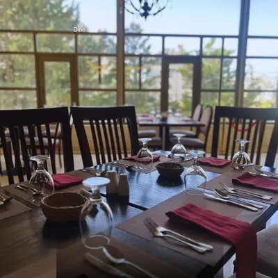 a wooden table with utensils on top of it at Amman Paradise Hotel in Amman