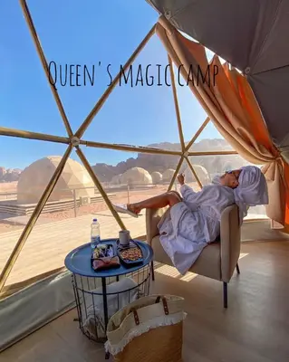 a woman laying on a chair in a tent at Queen's Magic Camp in Wadi Rum