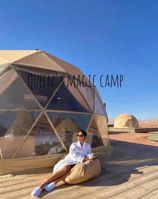 a woman laying in a tent in the desert at Queen's Magic Camp in Wadi Rum
