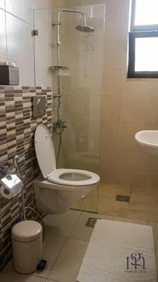 a bathroom with a toilet and a sink at Maison Gaia, A Stylish Apartment in the heart of Amman in Amman