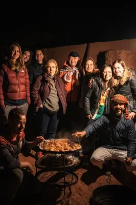 a group of people standing around a table at Magic Bedouin Star in Wadi Rum