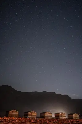a starry night with five buildings in the desert at Magic Bedouin Star in Wadi Rum