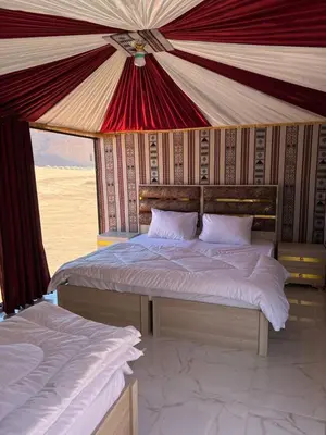 a bedroom with two beds in a tent at Wadi Rum Sand Camp in Disah