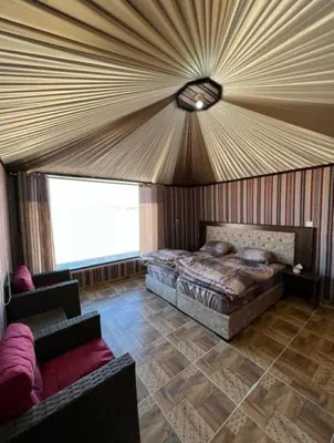 a bedroom with a bed and a ceiling at Enjoy Wadi Rum stars in Disah