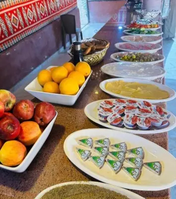 a buffet with plates of food on a table at Awad Bedouin camp in Wadi Rum