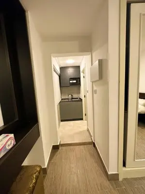 a hallway leading to a kitchen in a apartment at central apartment for rent 31 in Umm Uthainah