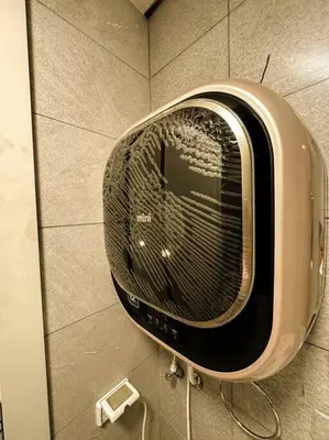 a toaster oven on the wall of a bathroom at central apartment for rent 31 in Umm Uthainah