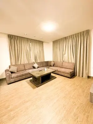 a living room with a couch and a table at central apartment for rent 30 in Umm Uthainah