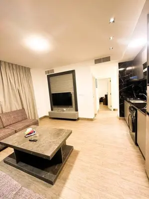a living room with a couch and a coffee table at central apartment for rent 30 in Umm Uthainah