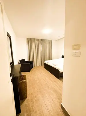 a hotel room with a bed and a couch at central apartment for rent 29 in Umm Uthainah