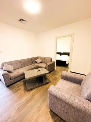 a living room with a couch and a table at central apartment for rent 28 in Umm Uthainah