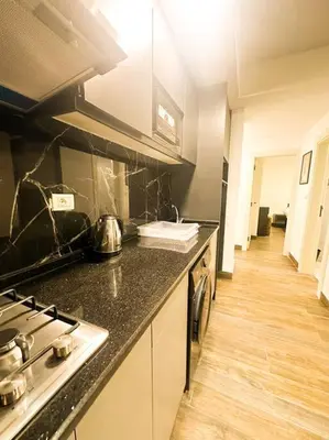 a kitchen with a stove and a counter top at central apartment for rent 25 in Umm Uthainah